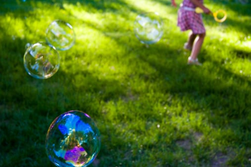 girl playing with bubbles