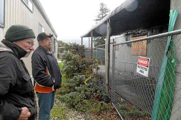Mike and Marcus survey the damage at the home they shared.
