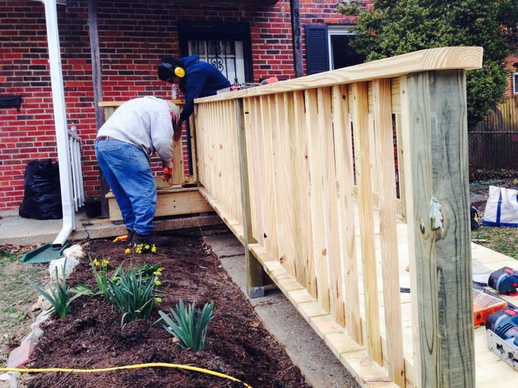 Neighbors putting the finishing touches on the ramp.