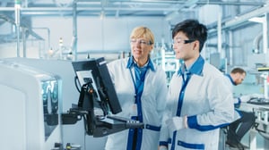 On High-Tech Factory Asian Engineer Talks with Female Supervisor, Use Computer for Programming Pick and Place Electronic Machinery for Printed Circuit Board Surface Mount Assembly Line. Production of PCB with SMT Machinery. On High-Tech Factory Asian Engineer Talks with Female Supervisor, Use Computer for Programming Pick and Place Electronic Machinery for Printed Circuit Board Surface Mount Assembly Line. Production of PCB with SMT Machinery.